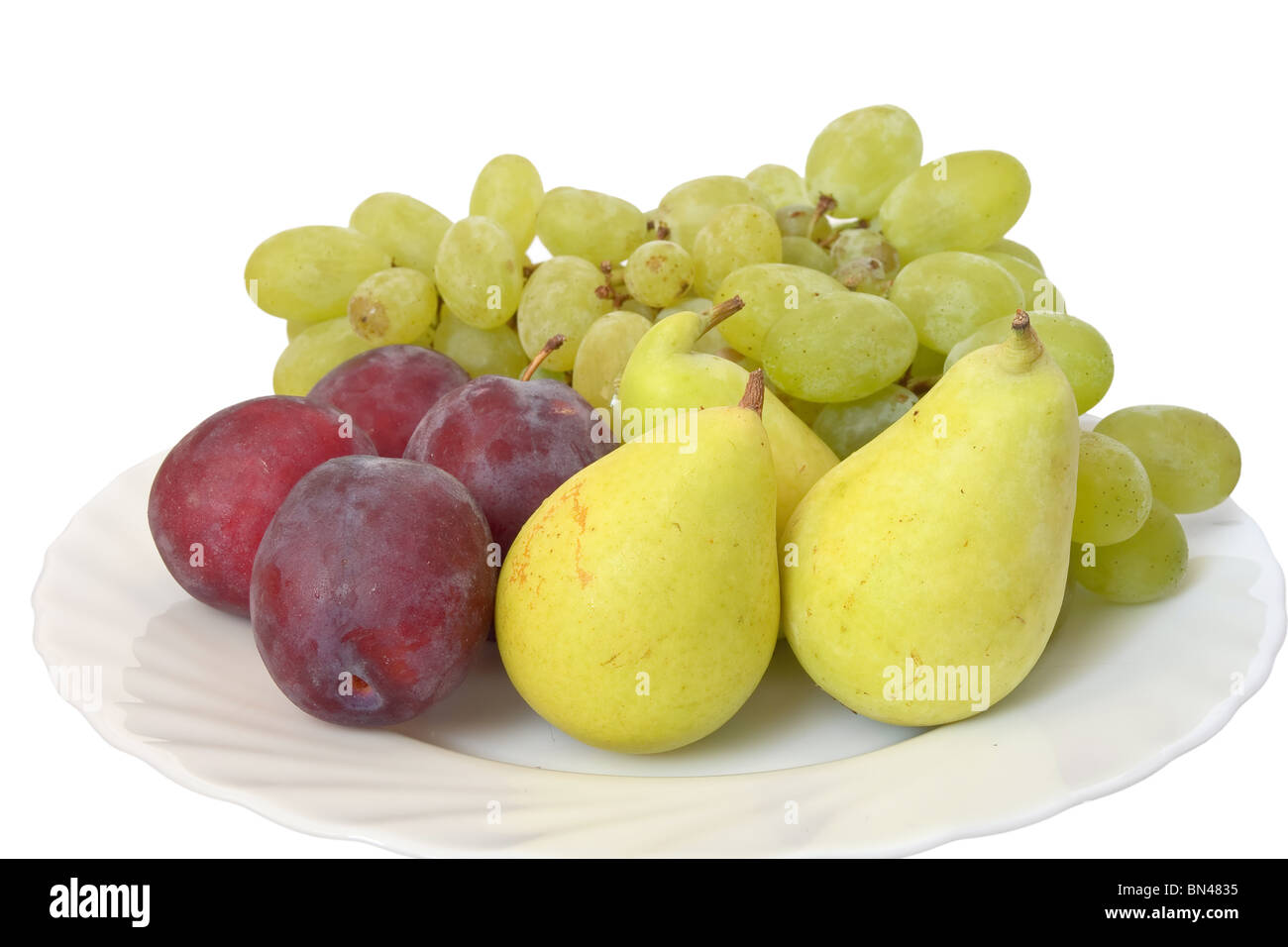 plate with plums, grapes and pears isolated on white background Stock Photo