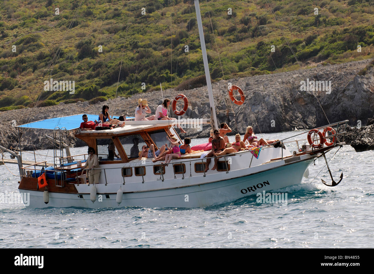 Holidaymakers sunbathing on a traditional Gulet boat off the Turkish coast close to Bodrum SW Turkey Stock Photo
