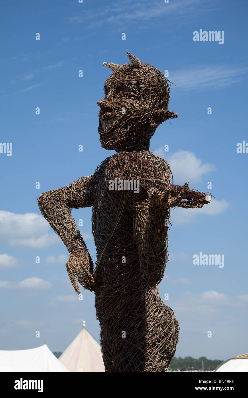 Willow statue in the green fields at the Glastonbury festival 2010