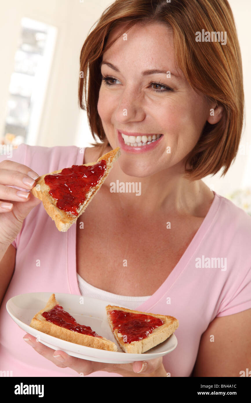WOMAN EATING TOAST Stock Photo Alamy