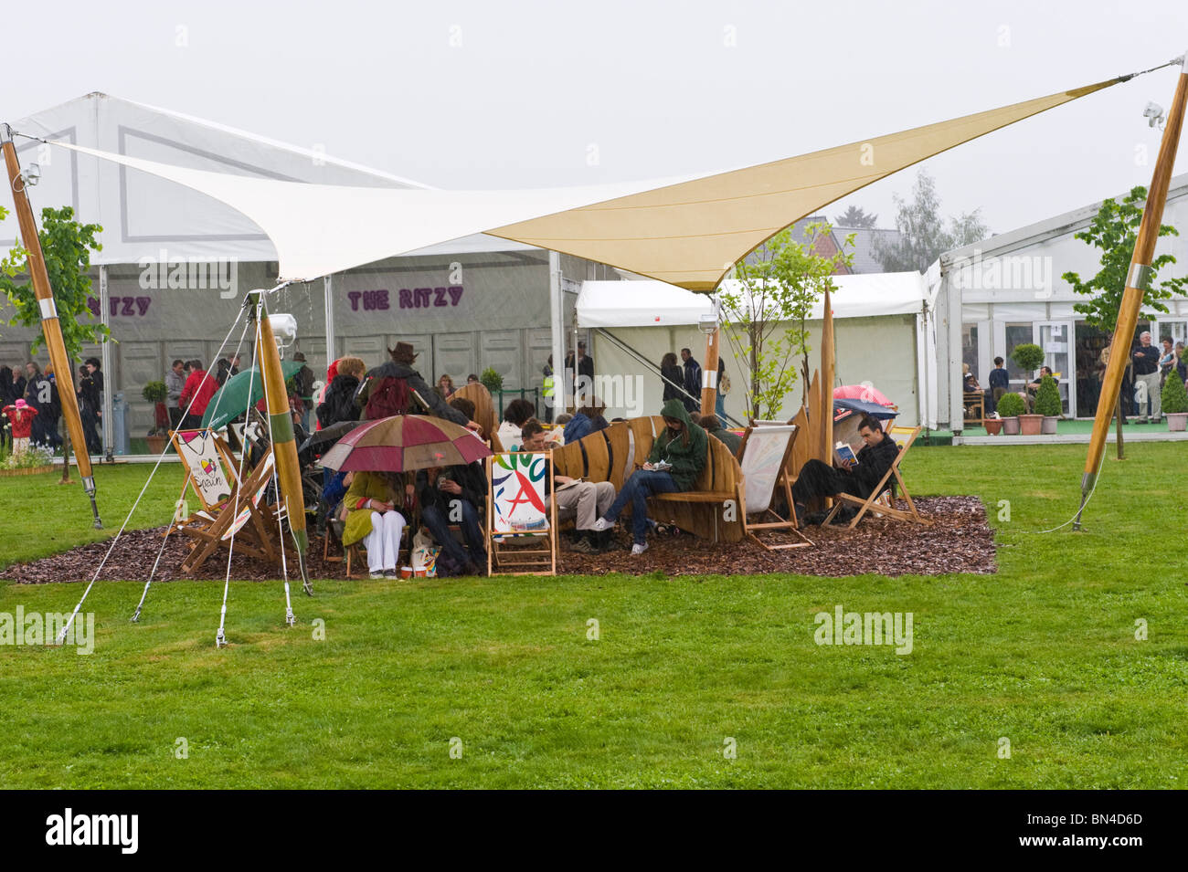 Visitors shelter from torrential rain at Hay Festival 2010 Hay on Wye Powys Wales UK Stock Photo