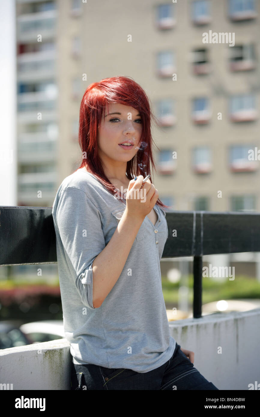 Red haired teenage girl smoking outside Stock Photo Alamy