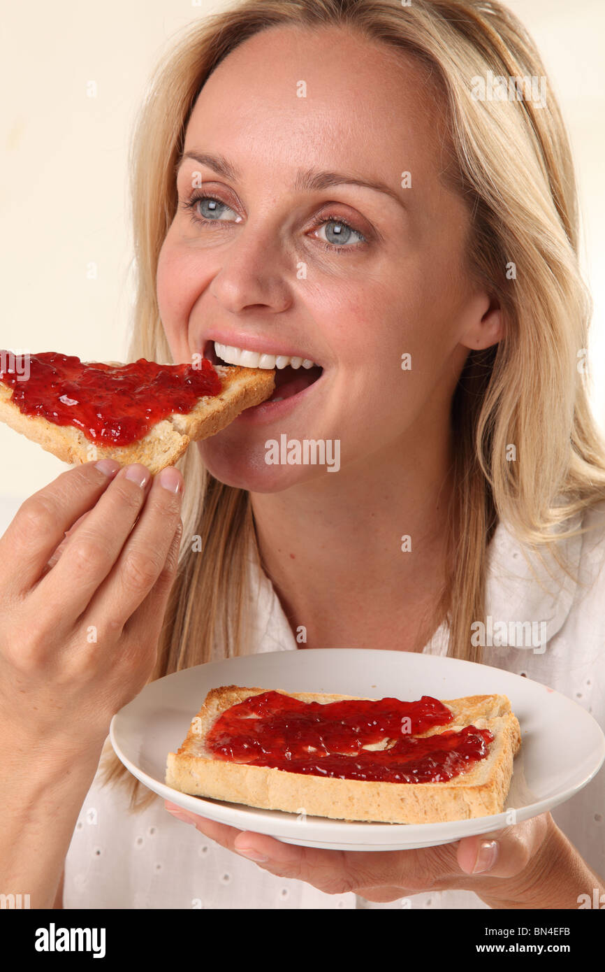 WOMAN EATING TOAST Stock Photo Alamy