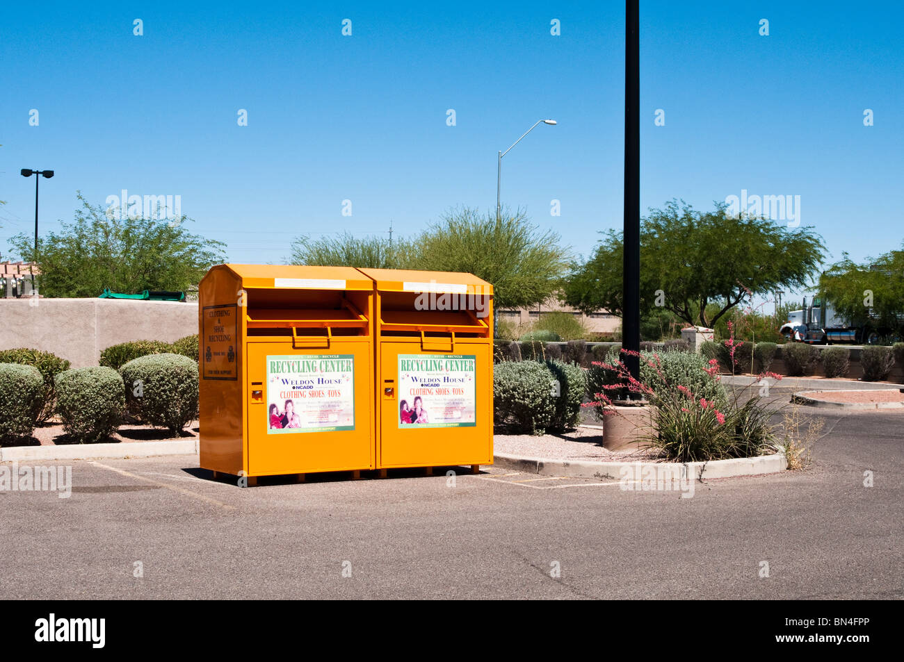 Donation boxes located where the public can conveniently recycle their unwanted clothing and shoes. Stock Photo