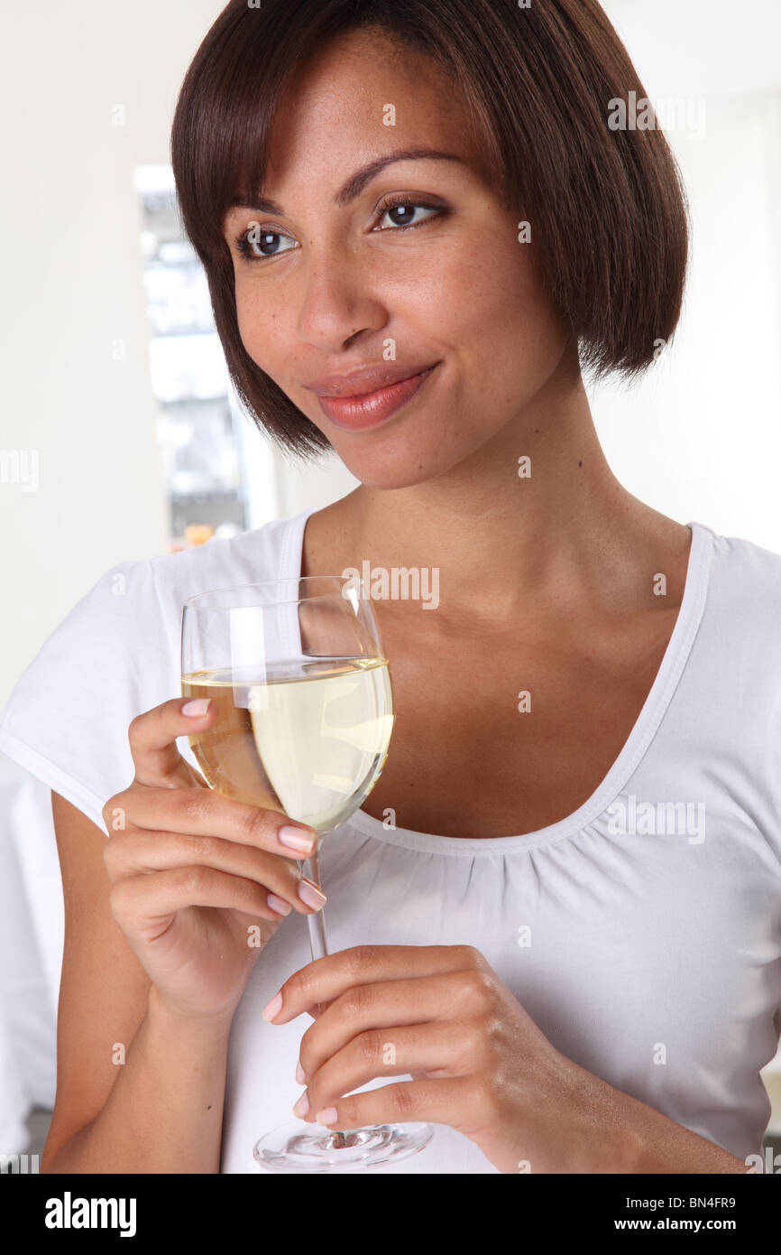 WOMAN HOLDING A GLASS OF WHITE WINE Stock Photo