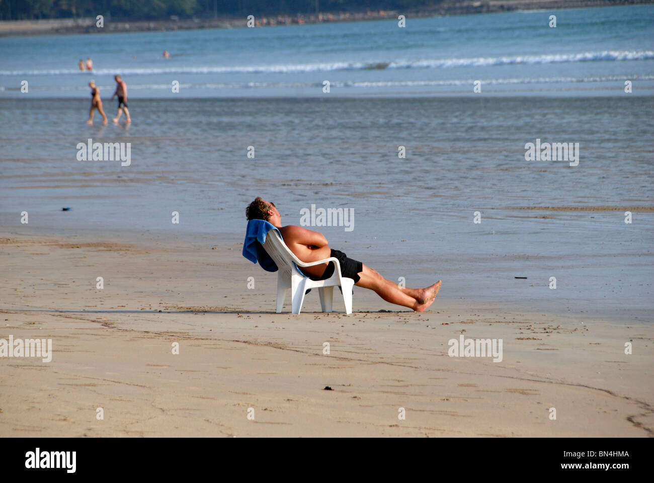 Foreign tourist relaxing in a chair on Ao Khlong Dao beach , Ko Lanta Island, Andaman Sea, southern Thailand Stock Photo
