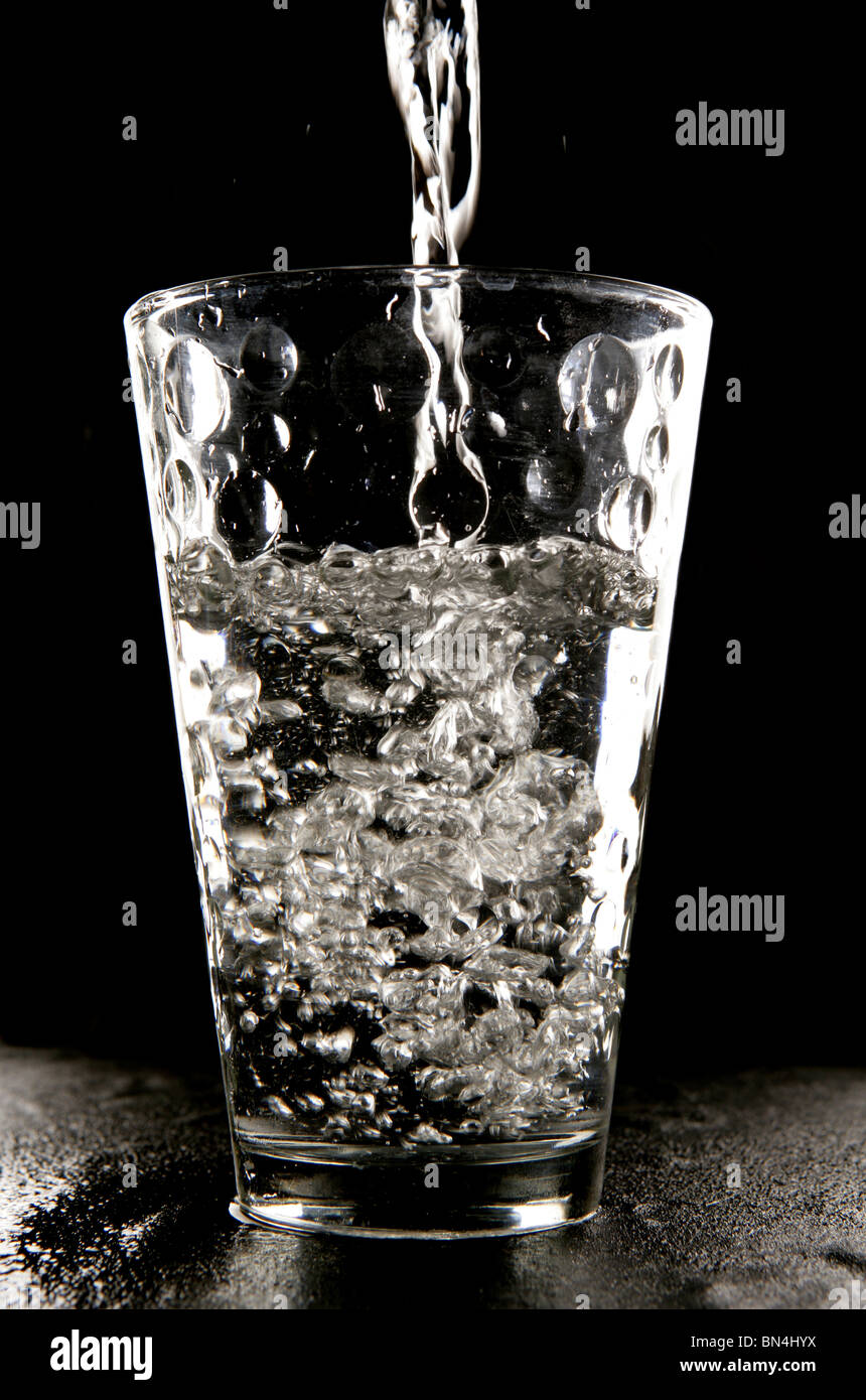 Water being poured into glass in studio Stock Photo Alamy
