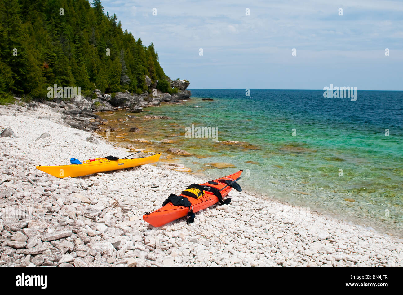 Yellow & orange kayaks on the beach Stock Photo Alamy
