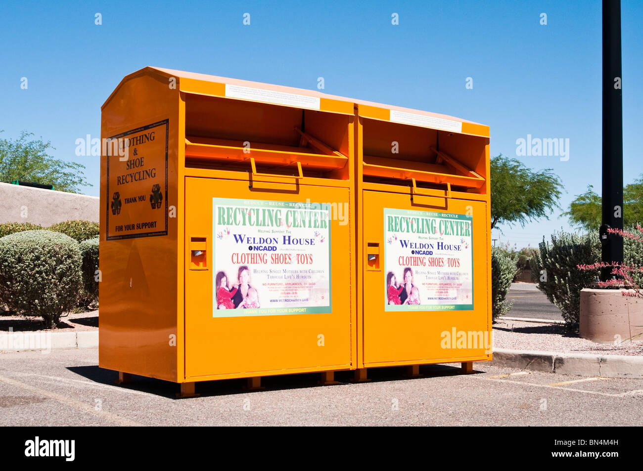 Donation boxes located where the public can conveniently recycle their unwanted clothing. Stock Photo