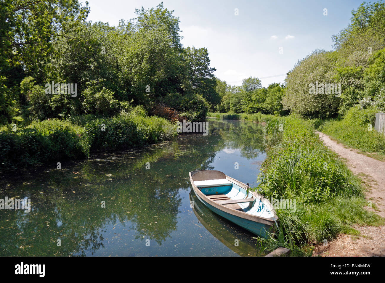 Rowing boat sitting on the Basingstoke Canal near the ruins of Odiham Castle, Hampshire, UK. Jun 2010 Stock Photo