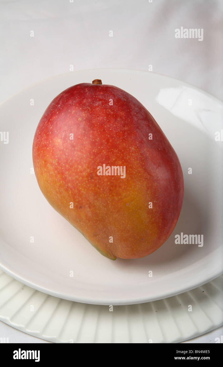 Fruit ; Red Mango ; Sweet ; Sour test ; Colourful ; One mango in a plate ; India Stock Photo