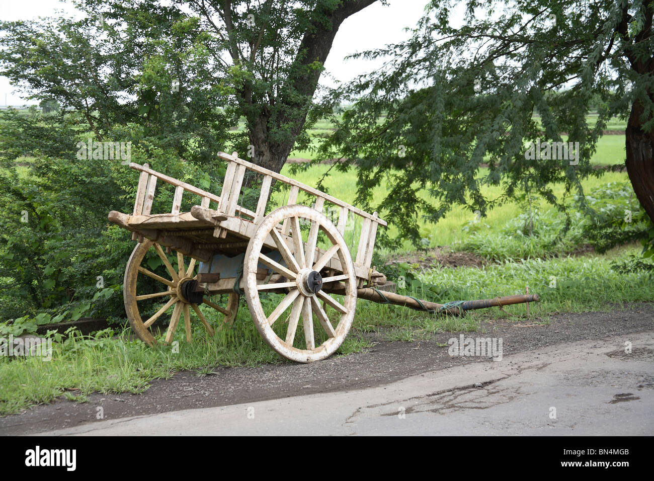 Bullock cart without bulls parked at the side of the road ; India Stock Photo