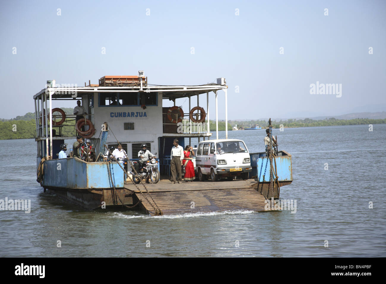 Ferry Boat  coming from Chorao Island to Ribander ; Dr. Salim Ali Bird Sanctuary in background ; Goa; India Stock Photo