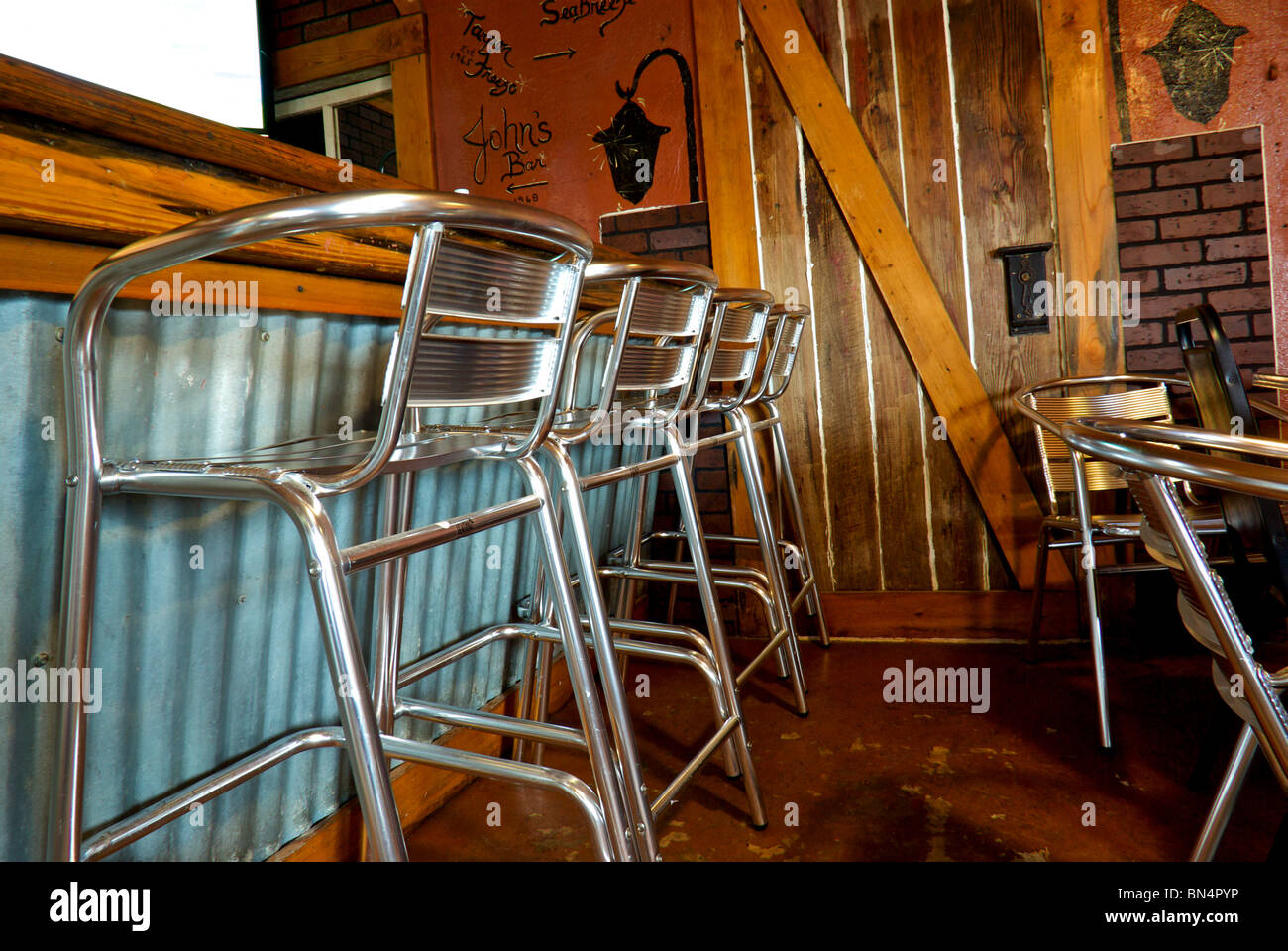Aluminum bar stool chairs in T Boy's Cajun Grill diner restaurant in Creole LA Stock Photo
