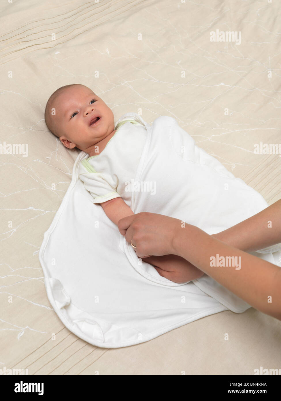 Mother swaddling a six week old baby boy Stock Photo Alamy