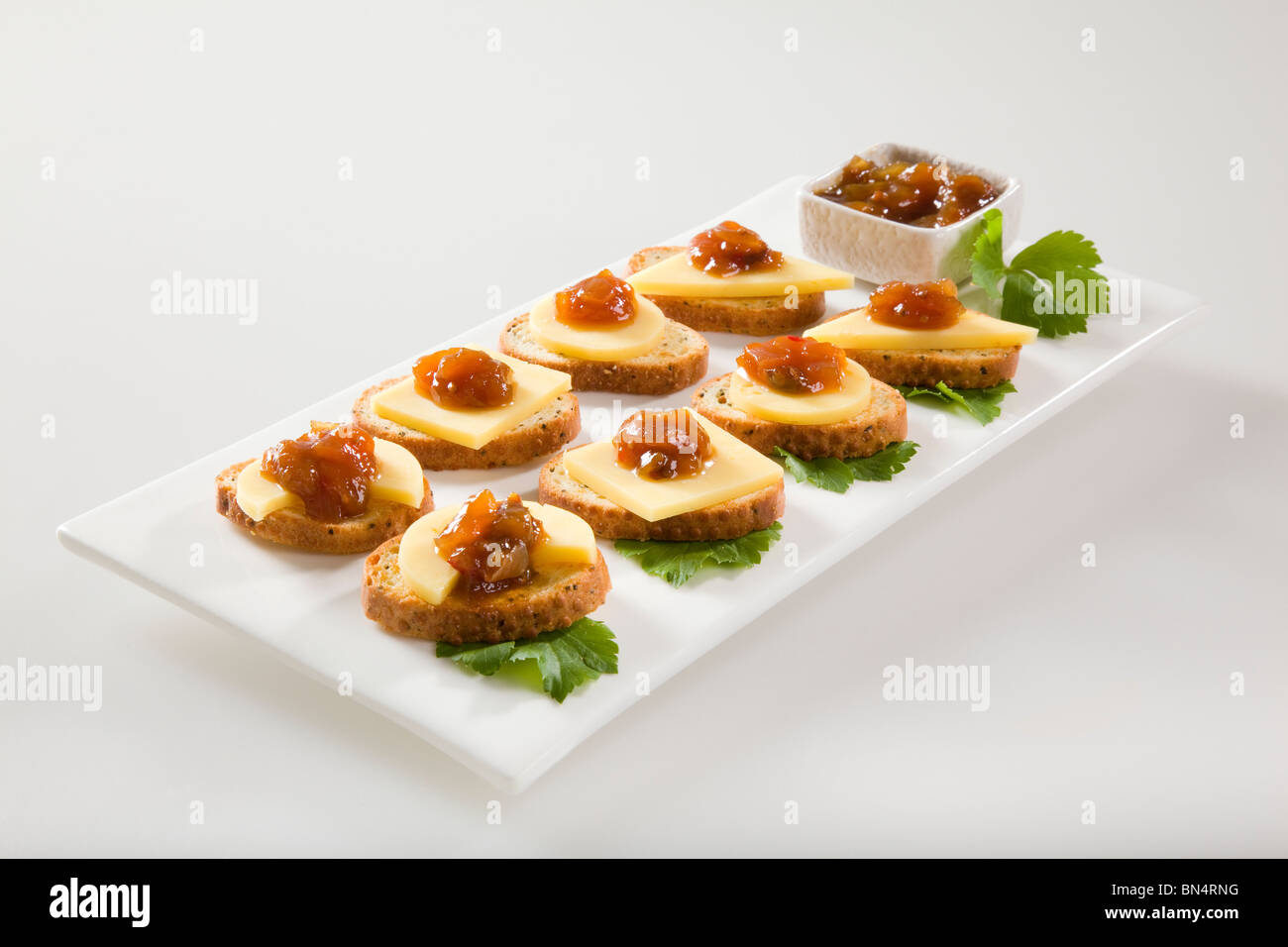 Bagel crisps with chutney and cheese Stock Photo