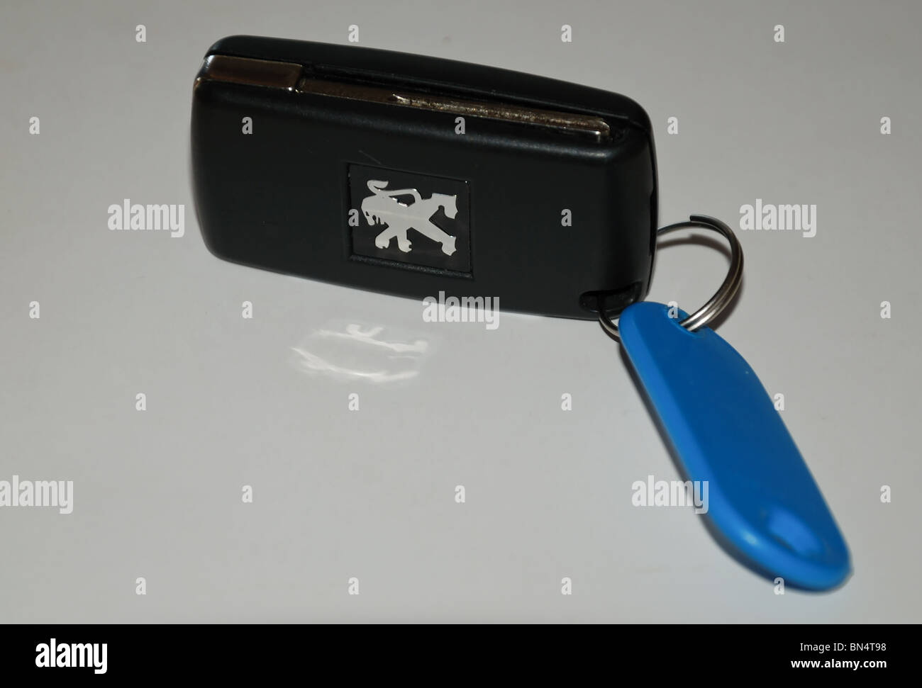 Car keys, car key (Peugeot) with Peugeot logo with keyring white background Stock Photo Alamy