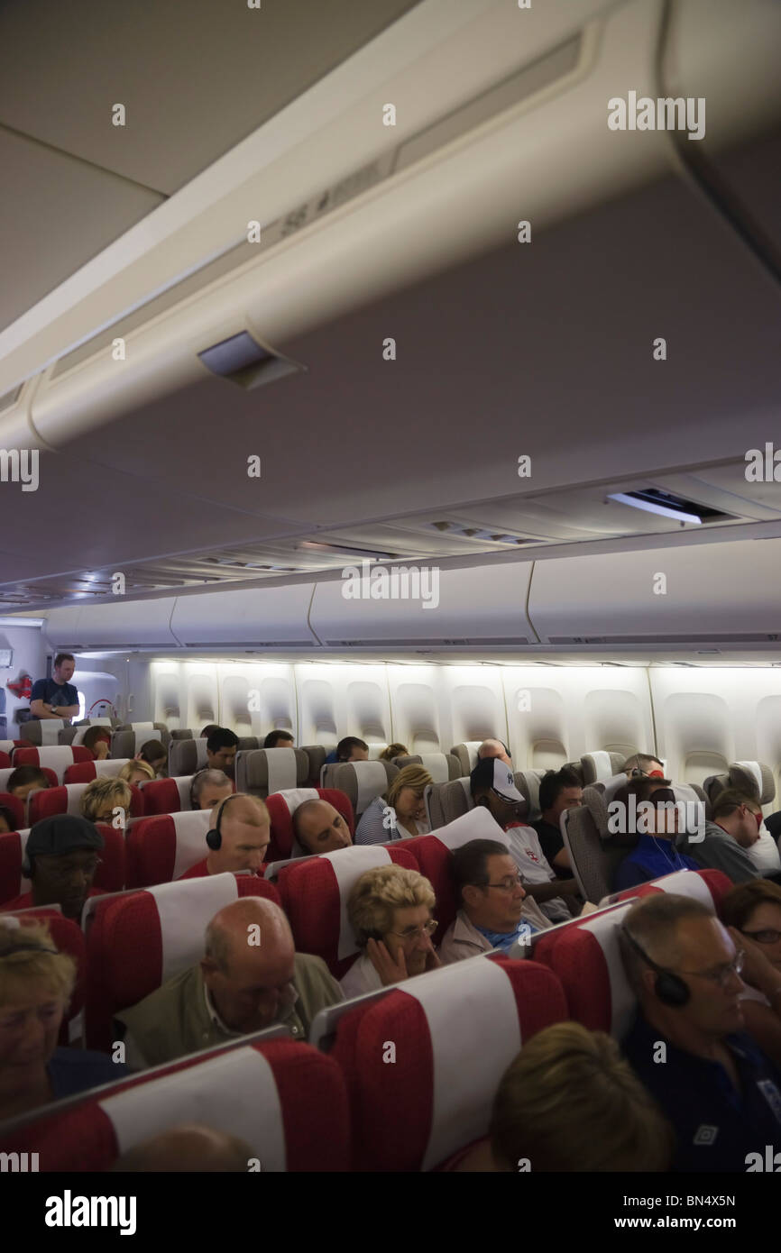 Interior of Virgin Atlantic transatlantic Boeing 747 jumbo jet with economy section and passengers Stock Photo