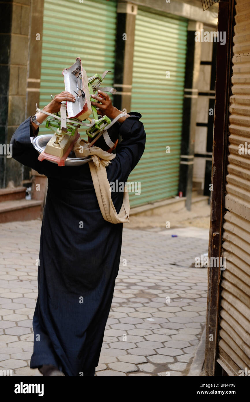 muslim man carrying scales, Khan elKhalili,Al Ghuriyya(al ghariya
