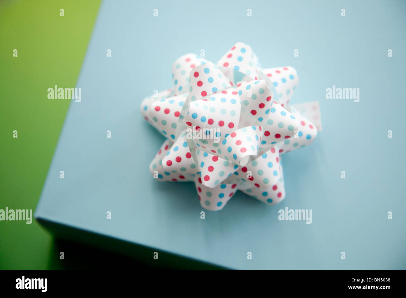 A gift box with a white polka dot bow Stock Photo