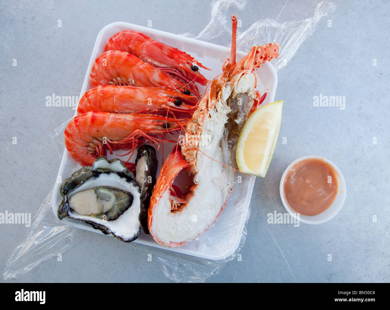 A meal containing Lobster, Shrimp, and Oysters at the Sydney Fish Market in Sydney, Australia Stock Photo
