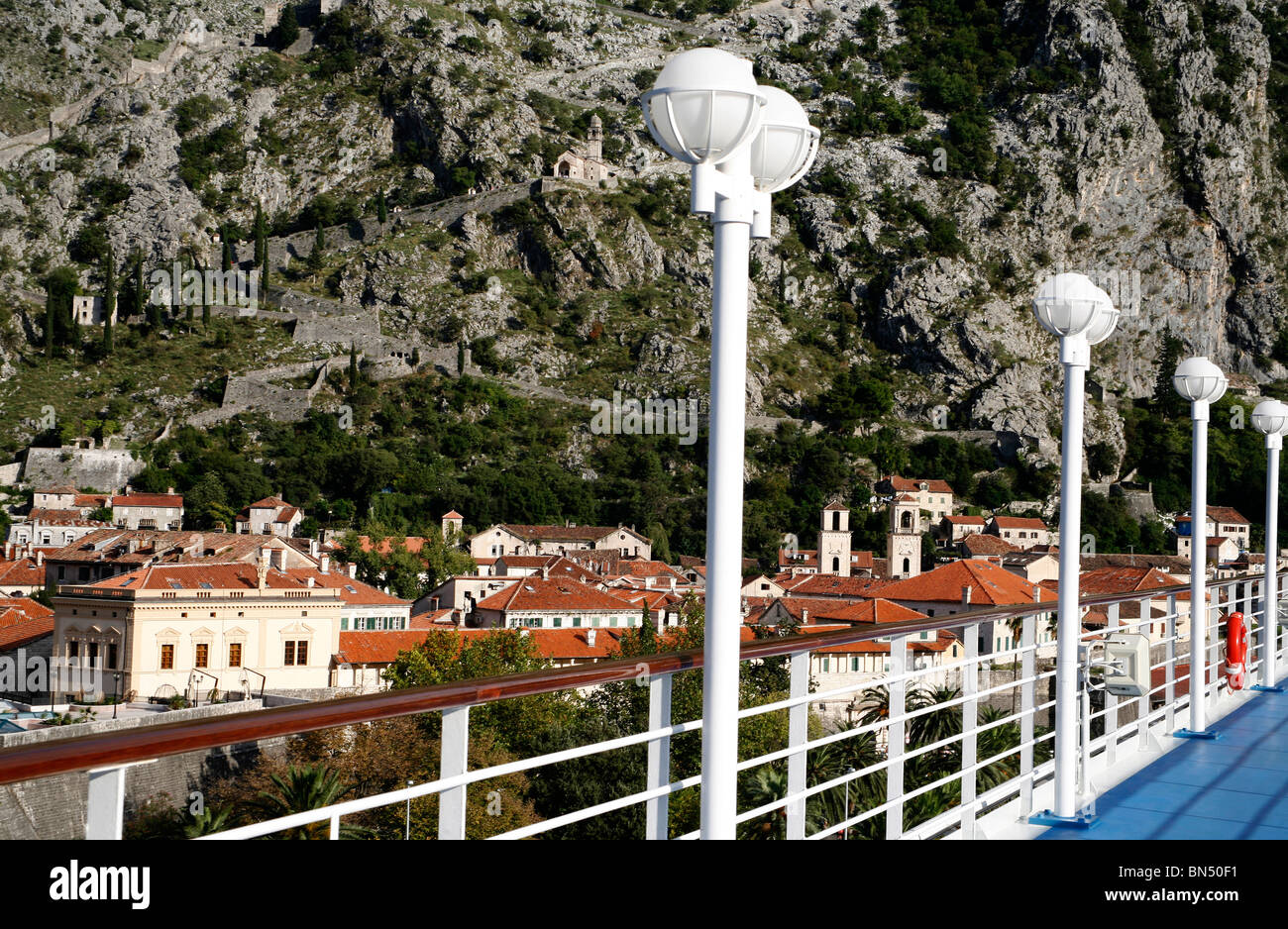 looking over cruise ship banister at Montenegro city hills in the background Stock Photo