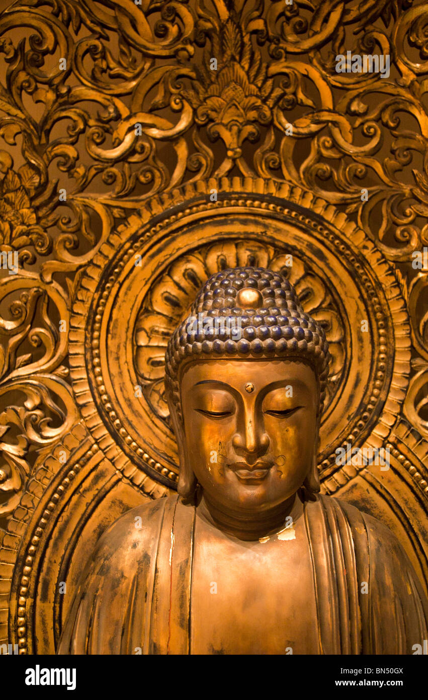 An intricate gilded Buddha statue at the Buddha Tooth Relic Temple in