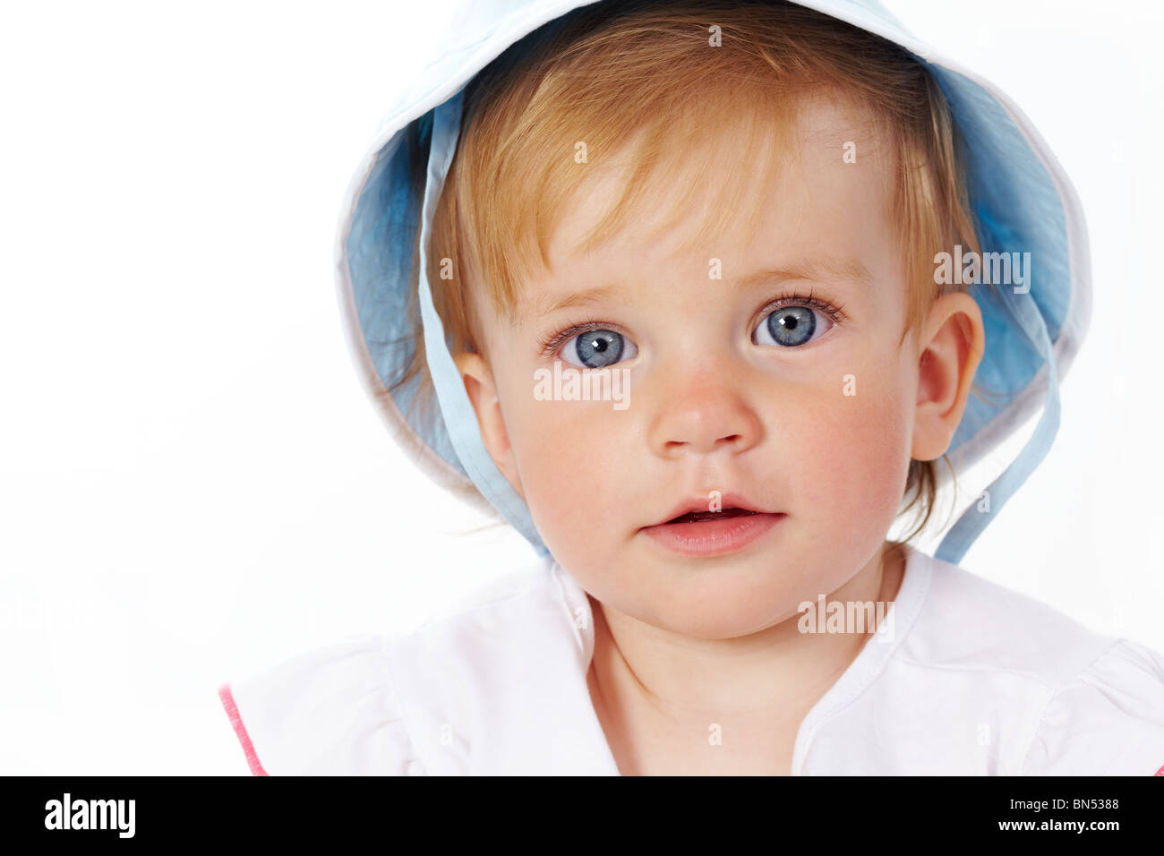 Portrait of cute child looking at camera over white background Stock ...