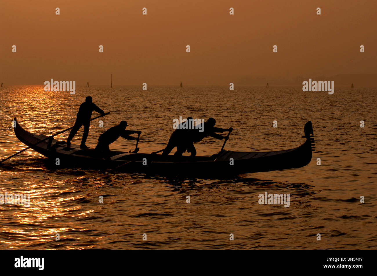 Gondola in open water at sunset Venice Stock Photo - Alamy