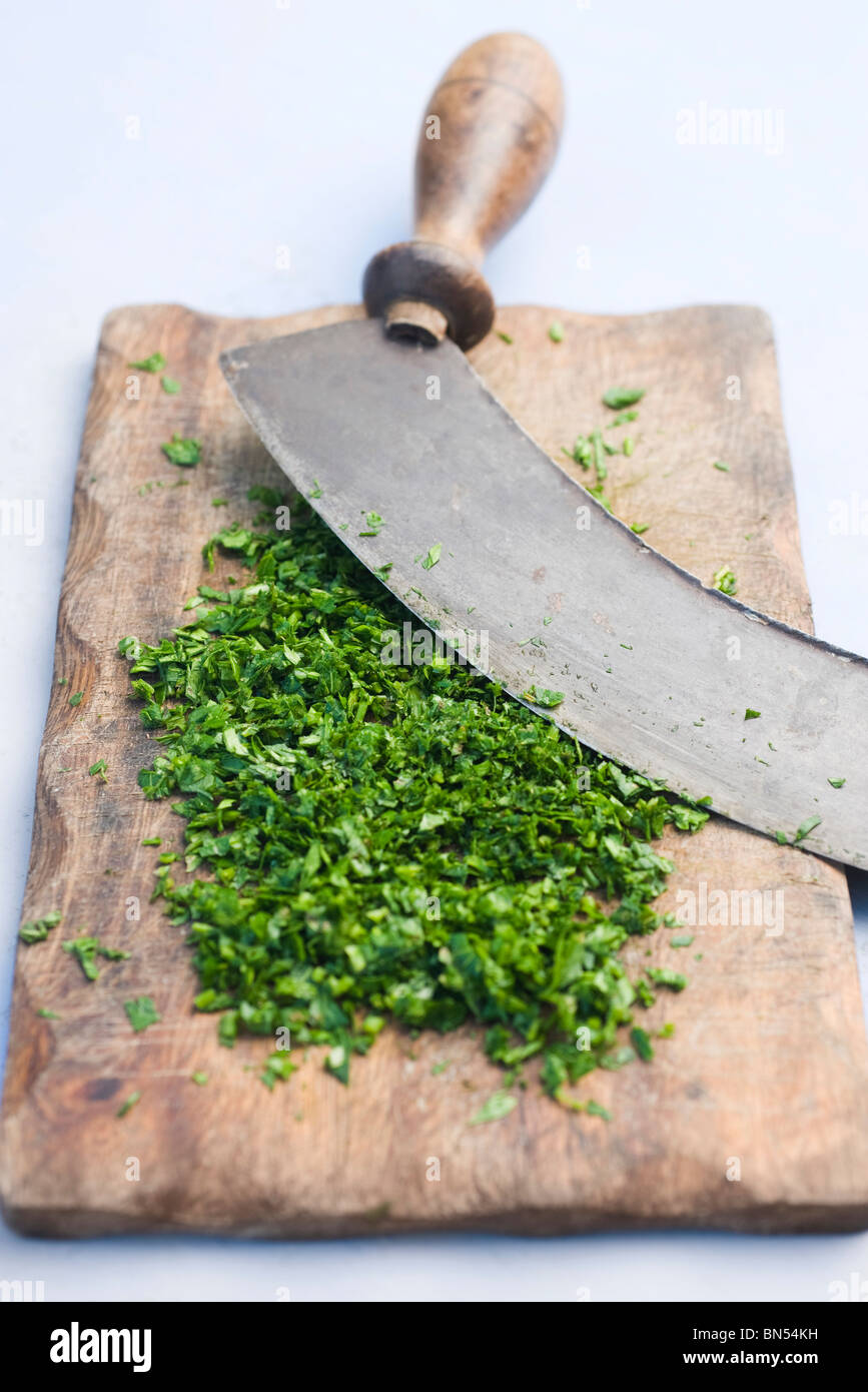 Freshly chopped herbs on cutting board Stock Photo Alamy