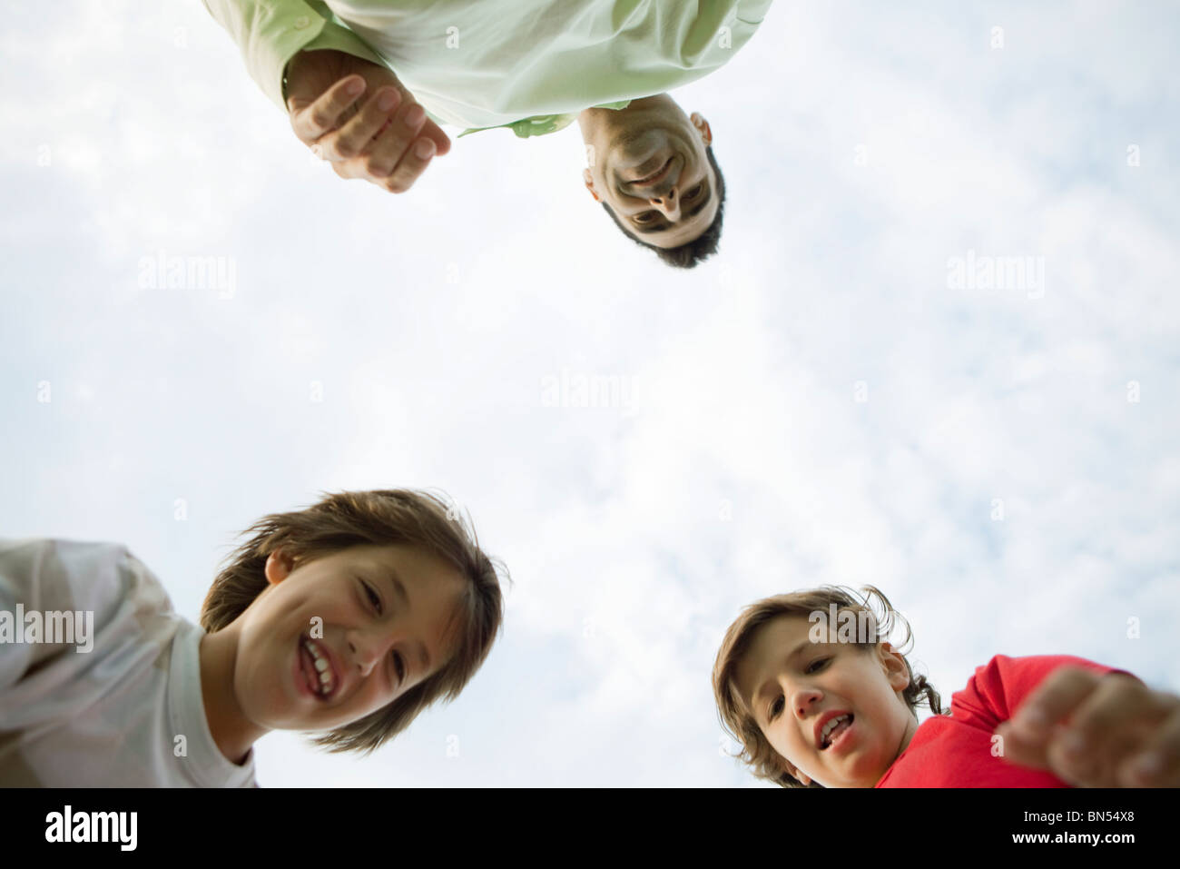 Father and sons outdoors, low angle view Stock Photo