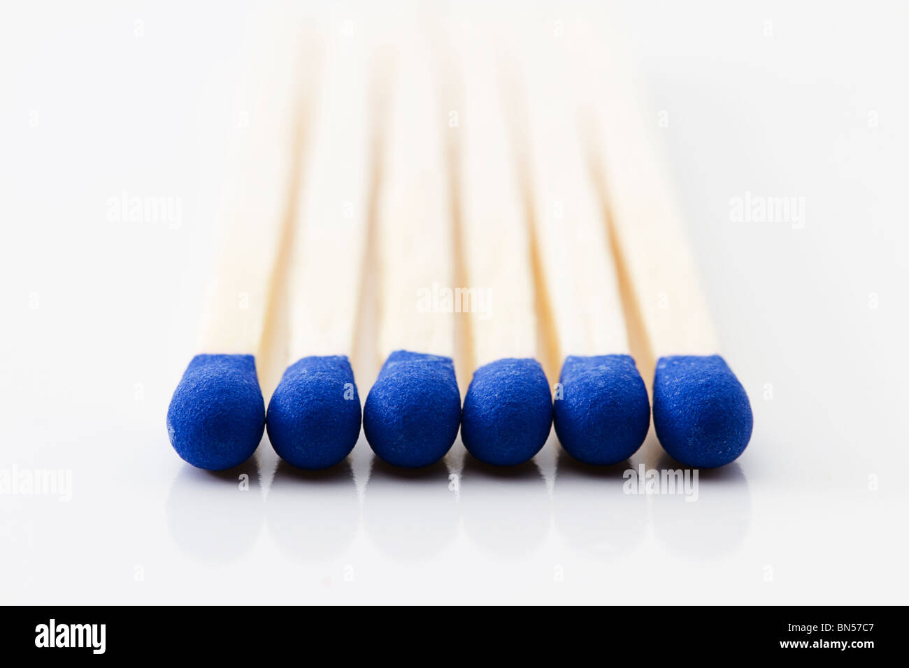 macro of some blue match heads on white background Stock Photo