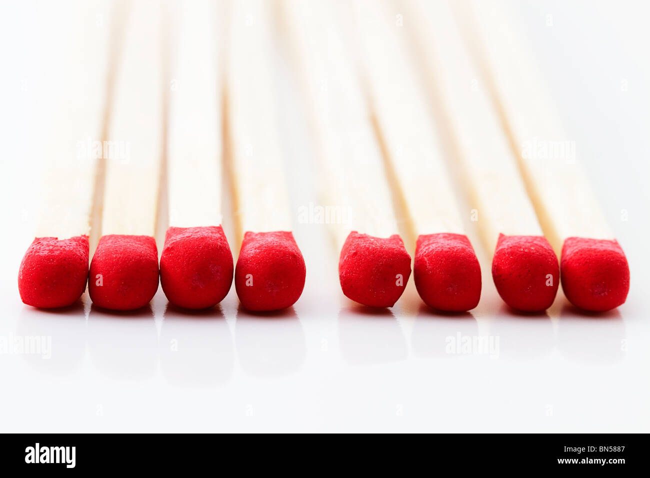 closeup of some red match heads on white background Stock Photo