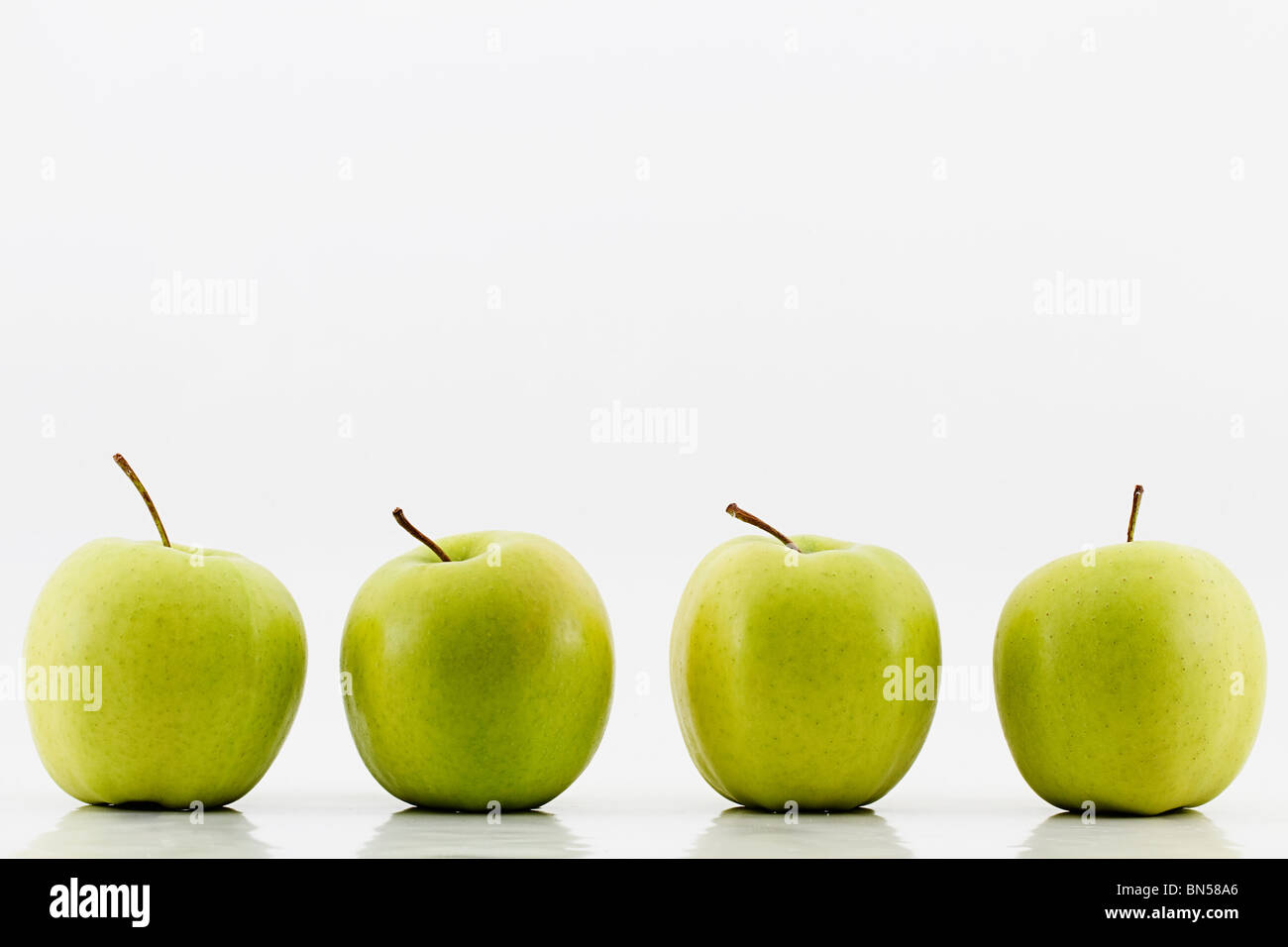 four green apples on white background Stock Photo