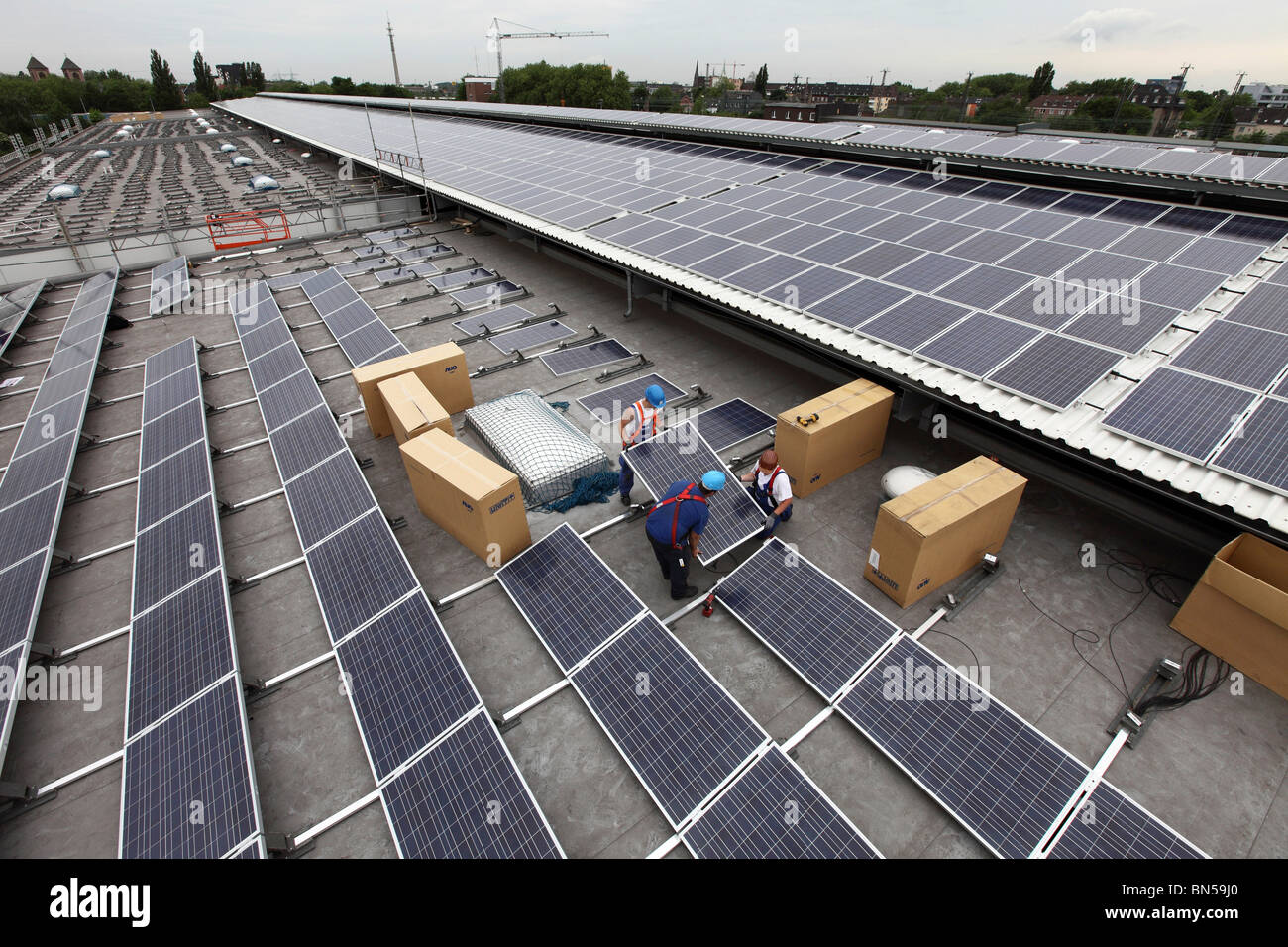 Construction of a big solar power plant, on a huge flat roof of a