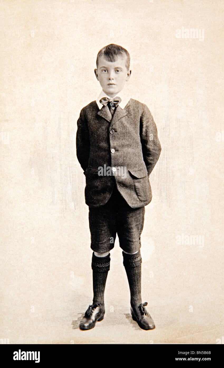 family history formal portrait of boy dating from 1920s wearing short trousers and long socks Stock Photo