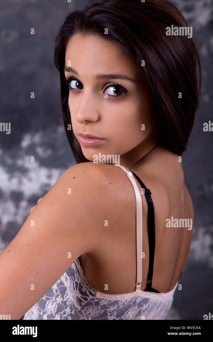 young beautiful brunette portrait against black background Stock Photo ...