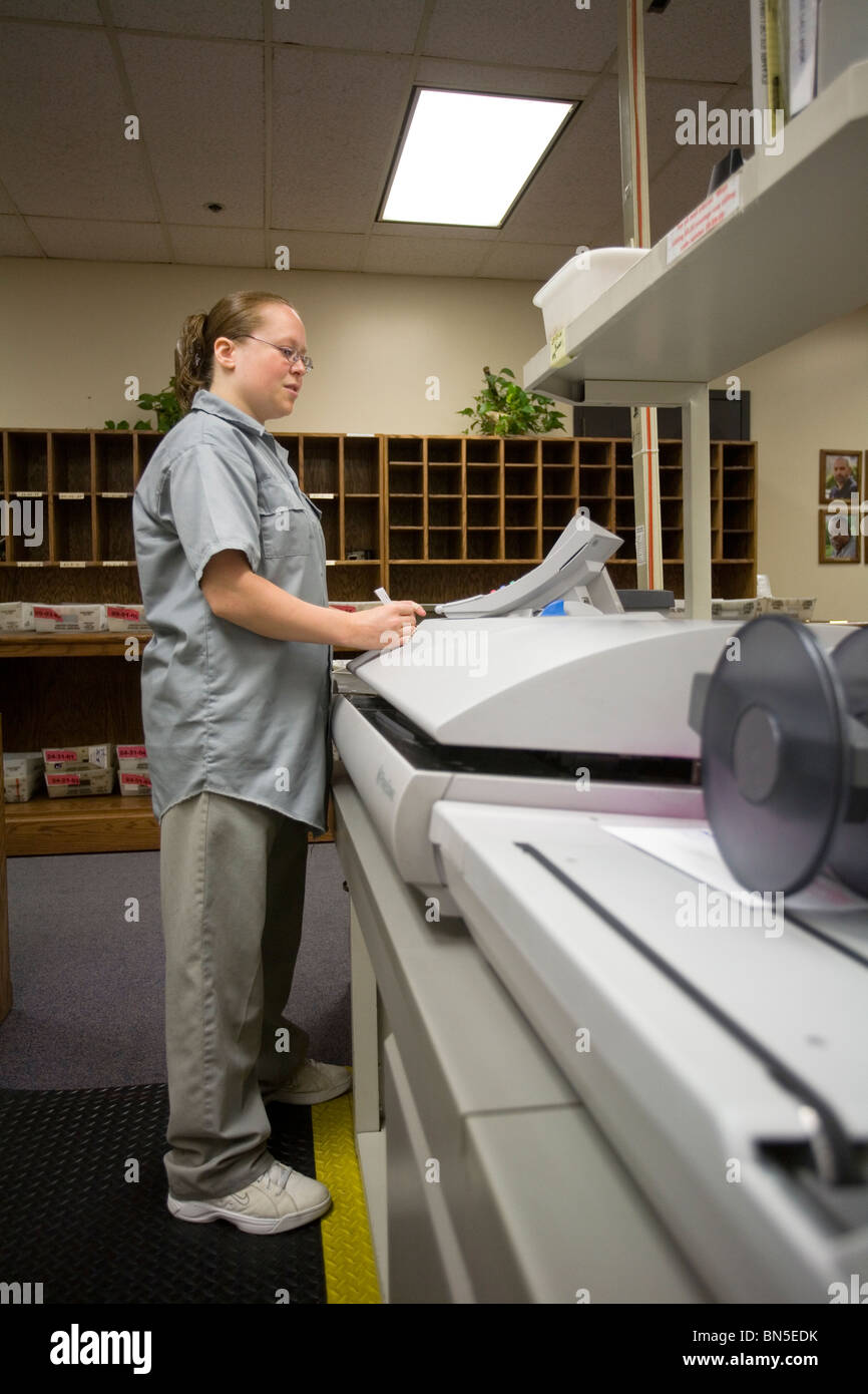 Female inmates from work release working in the mail room at the
