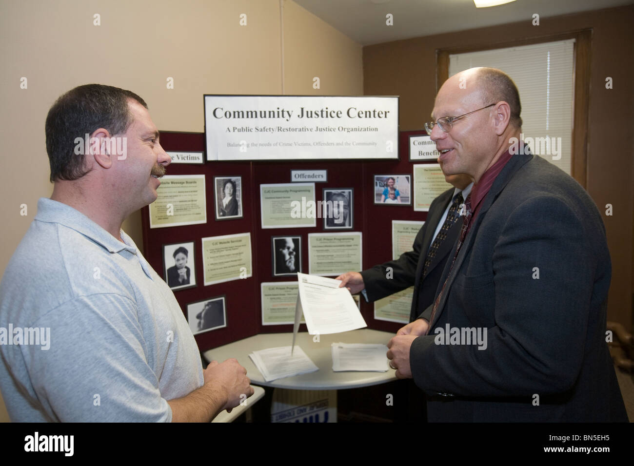 Parole officers talking at job fair site. Nebraska Adult Parole