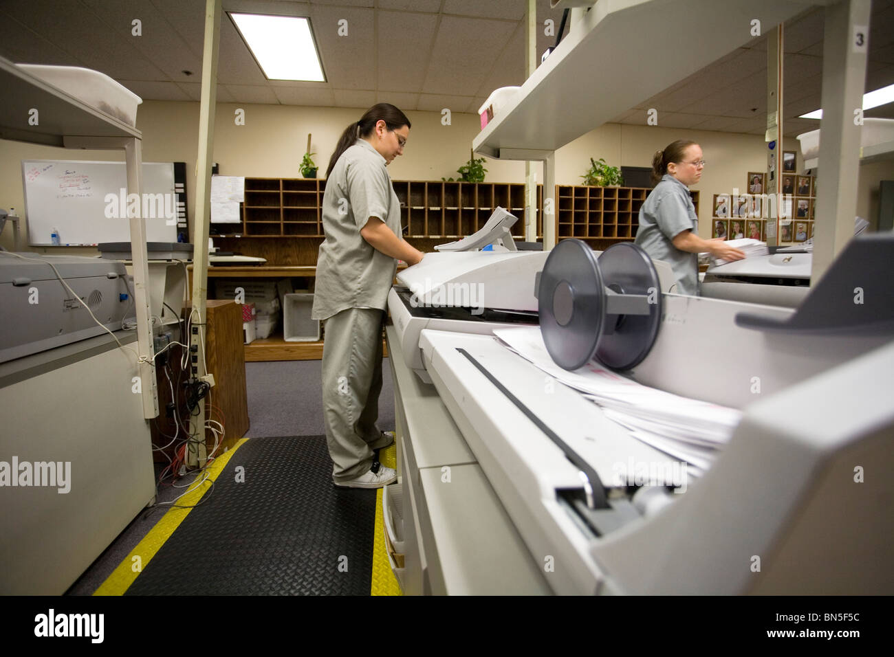 Female inmates from work release working in the mail room at the