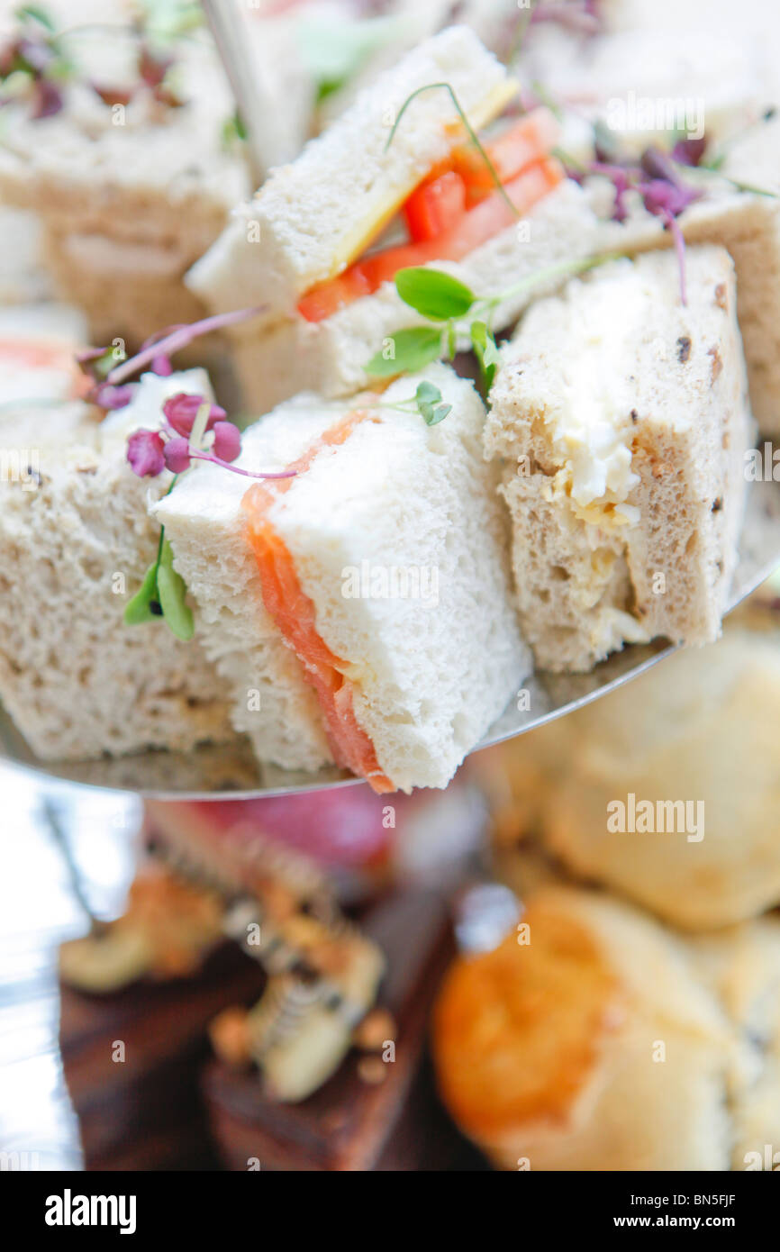 Afternoon tea of sandwiches and cakes. Stock Photo