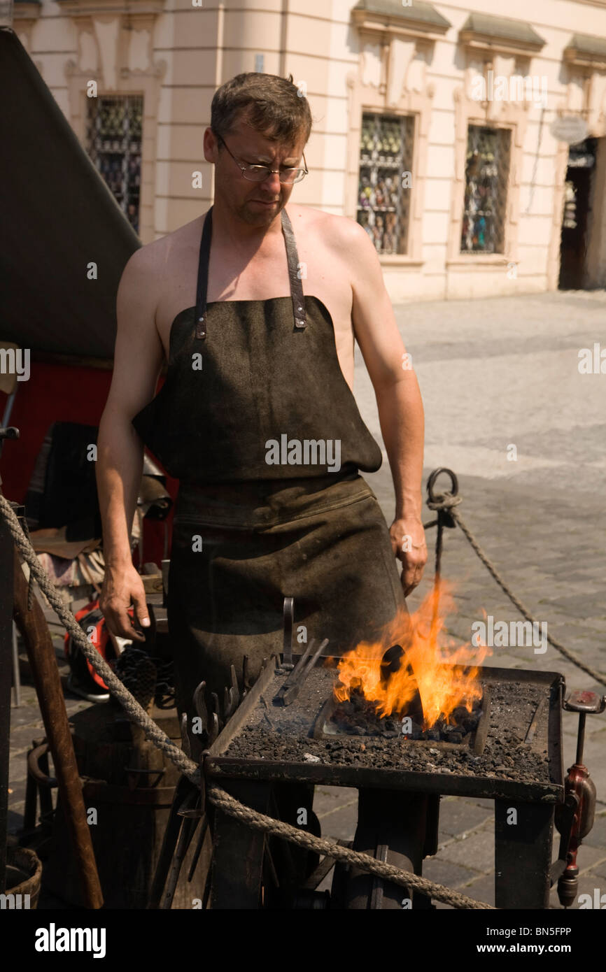 Blacksmith firing up with his foot bellows. Stock Photo