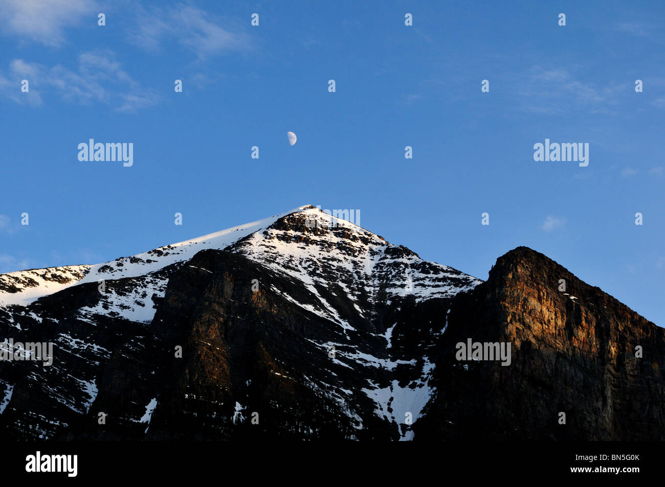 Moon hanging over mountains. Banff National Park, Alberta, Canada. Stock Photo