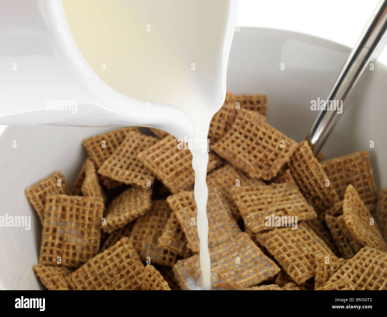 Pouring Milk onto Cereal Stock Photo