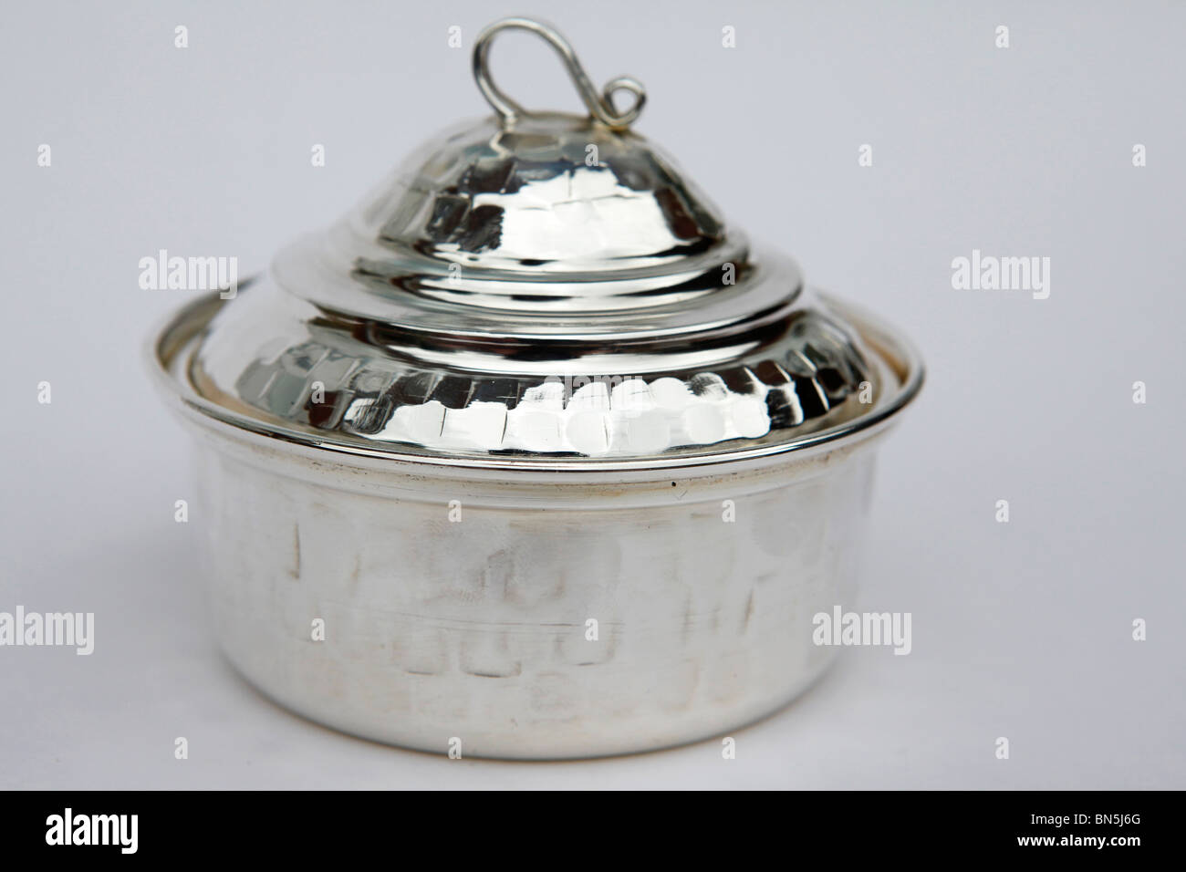 A metallic Tunisian bowl, fashioned from red brass and then polished and coated in silver. Stock Photo