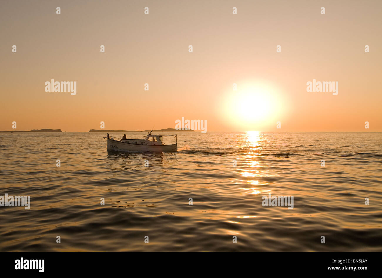 Boat at Sunset, San Antonio Bay, Ibiza, Balearics, Spain Stock Photo