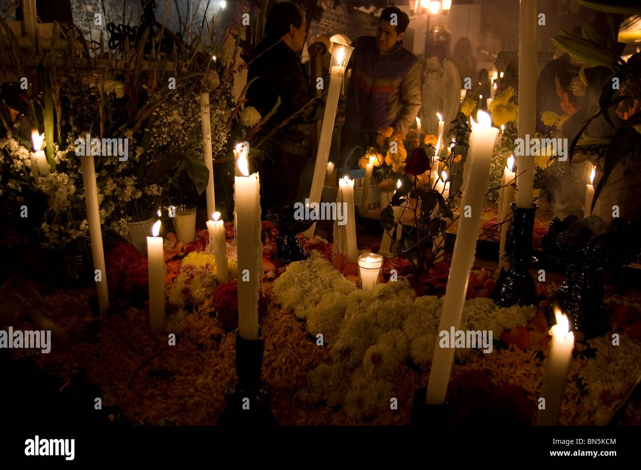 Tomb decorated with flowers and candles on the day of the dead in