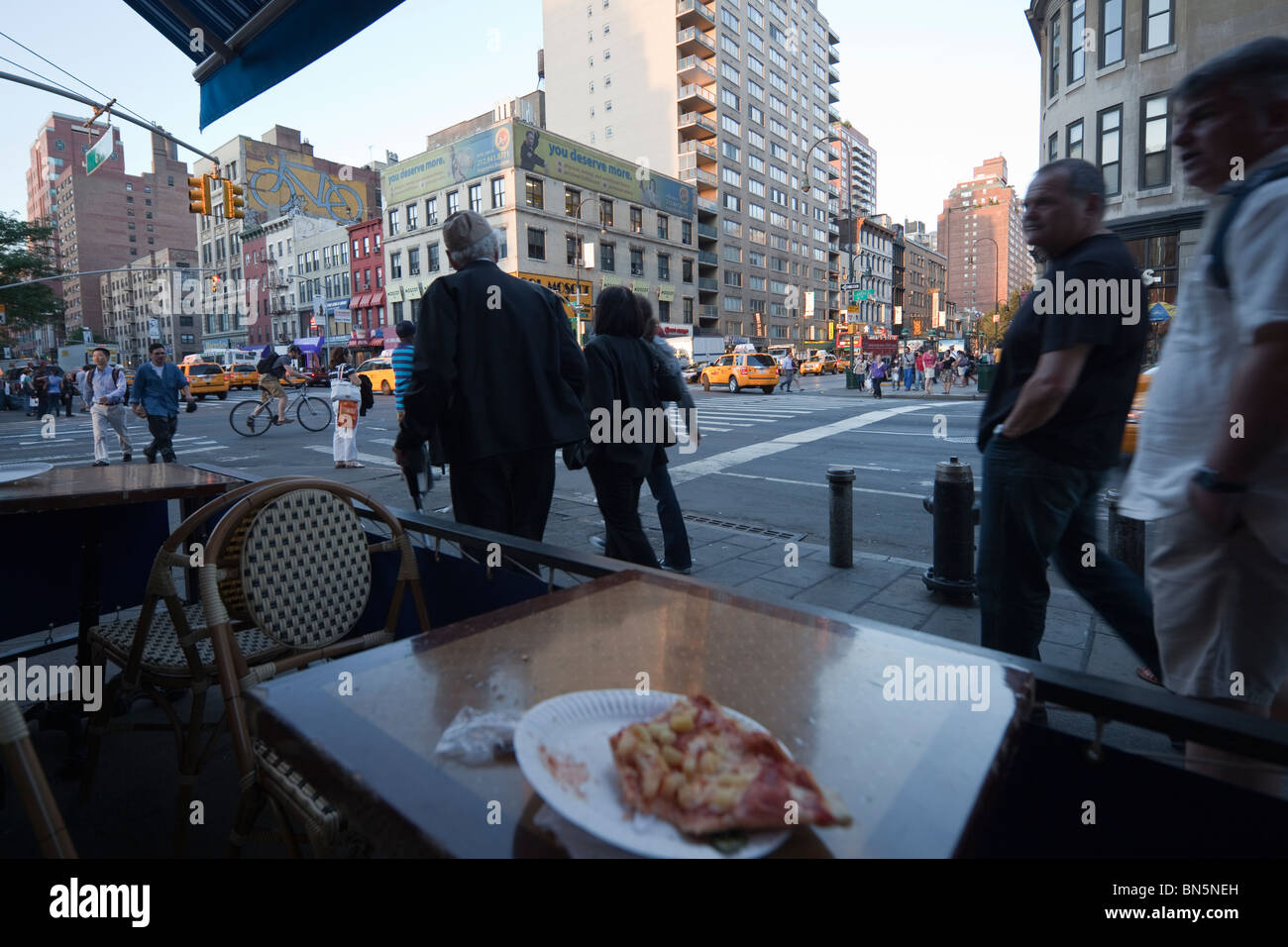 street scene with unfinished pizza, pedestrians, 41st Street and 8th Avenue, New York City Stock Photo