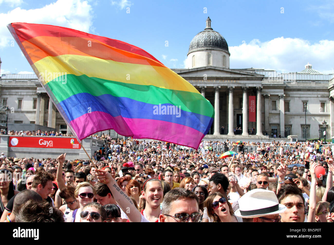 Rainbow flag and crowd in Trafalgar Square at the 40th Anniversary of Pride - Gay Pride Parade in London, 3rd July 2010 Stock Photo