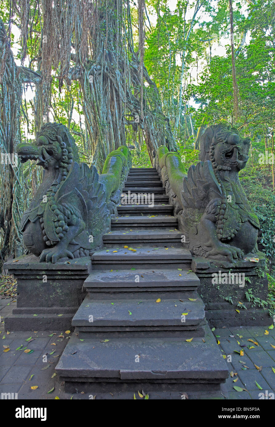 Two huge stone dragon statues which guard the stairs at the Holy Bathing Pool and Temple. Sacred Monkey Forest. Ubud, Bali. Stock Photo